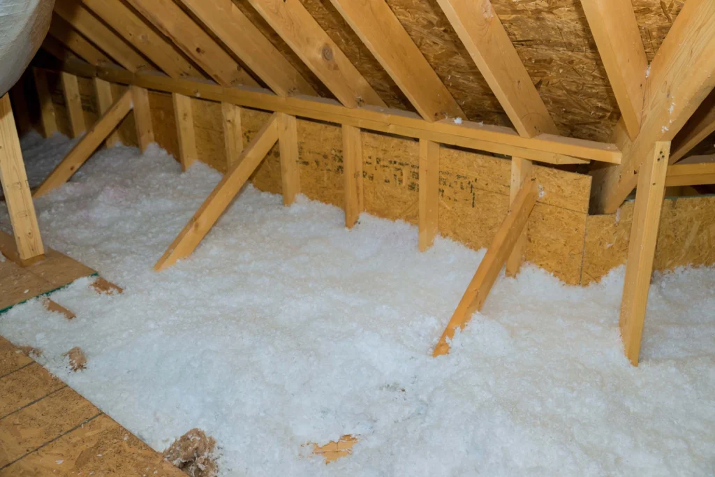 New homes attic insulation roof is being poured with eco wool insulation for purpose of insulating it. blown-in insulation