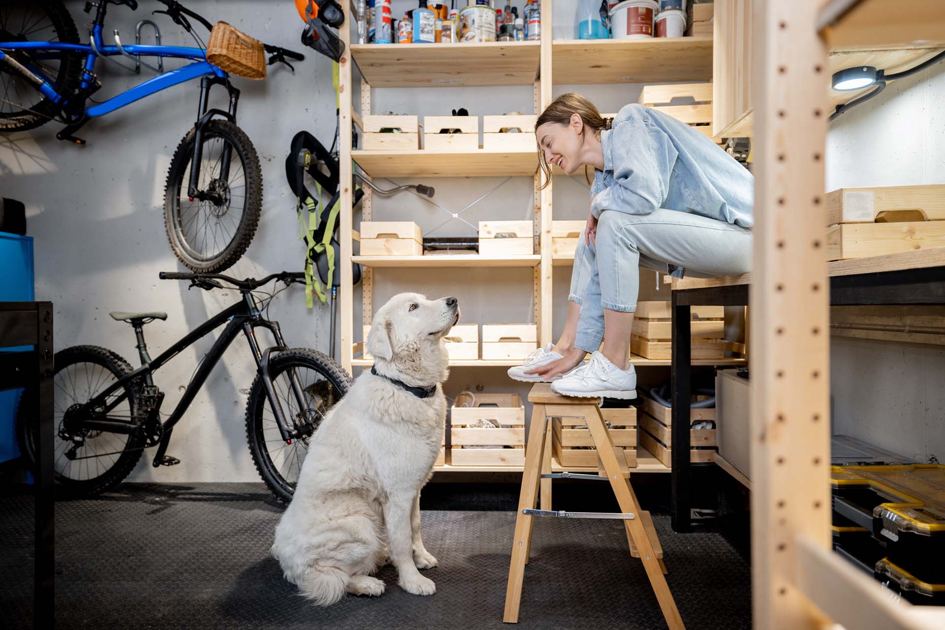 Woman interacting with dog in garage