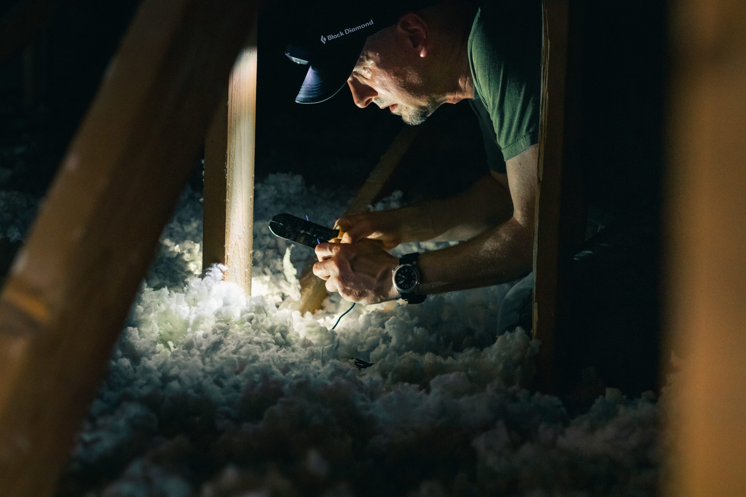 a worker inspecting a crawl space