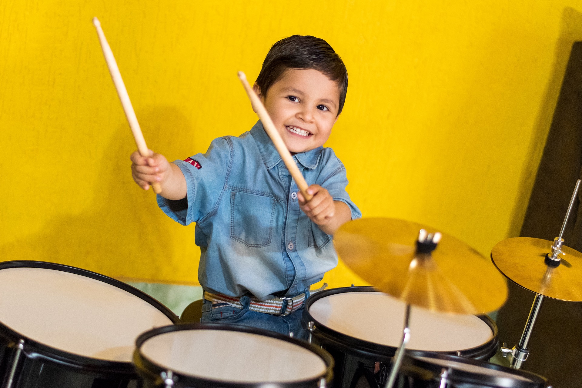 Drumming boy in a soundproofed home using insulation