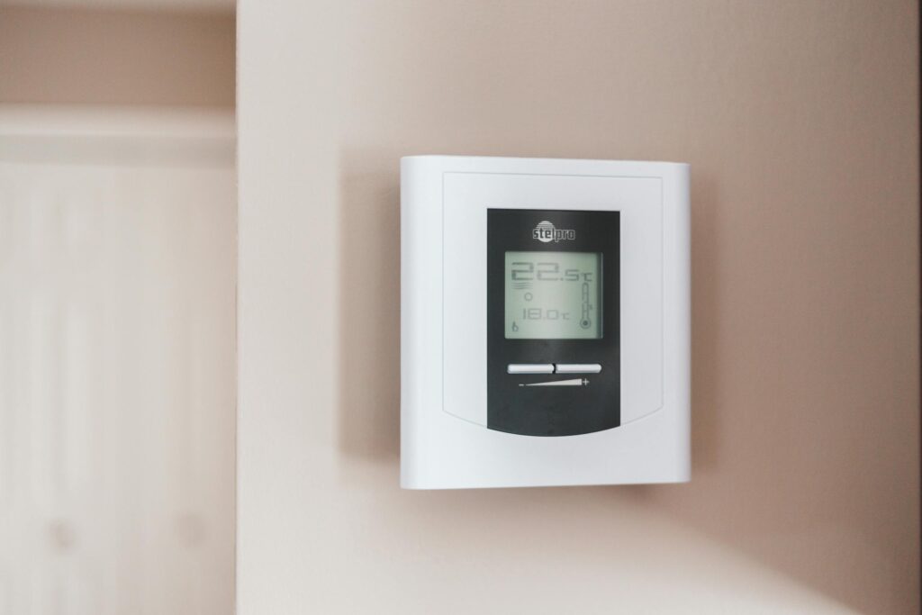 Digital thermostat on beige wall