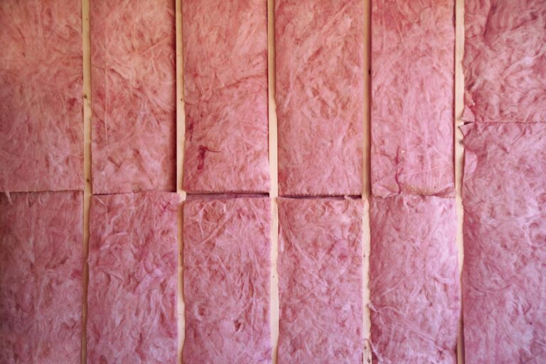 Pink fiberglass insulation installed in wall frame
