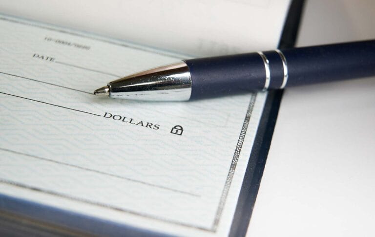 Checkbook with a pen on top.