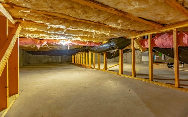 Empty basement with insulation and beams