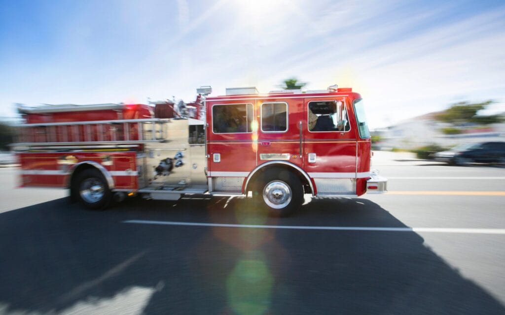 Installing-Smoke-and-CO-Detectors Firetruck going down the street